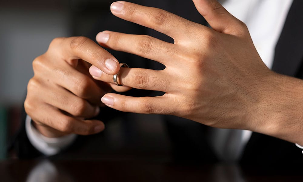 man in San Antonio removing wedding ring after working with a divorce lawyer